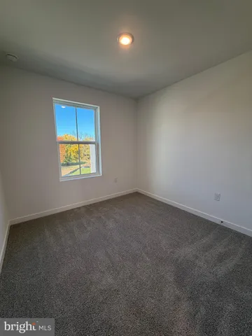 a view of an empty room and a window