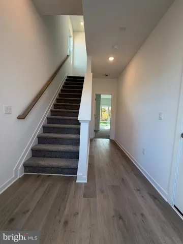 a view of entryway and hall with wooden floor