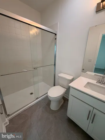 a bathroom with a toilet a sink and shower