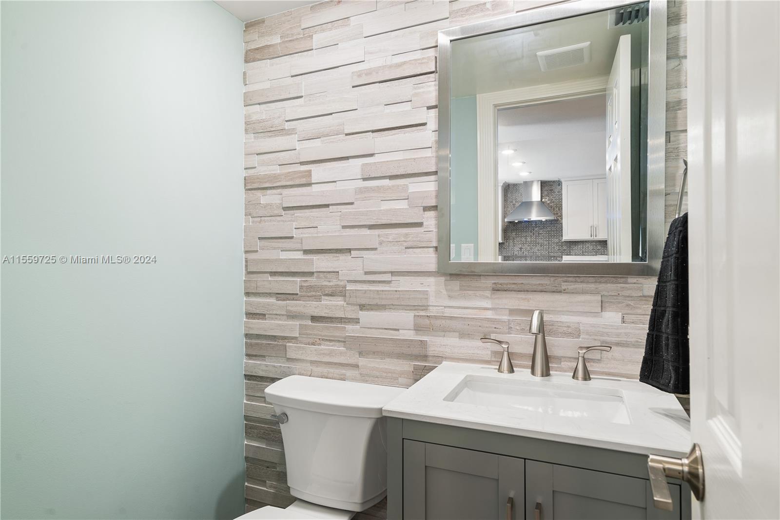 209 Sanctuary Dr., Unit 209 Key Largo, FL 33037 - Photo 13 of 43 a bathroom with a sink a toilet and mirror