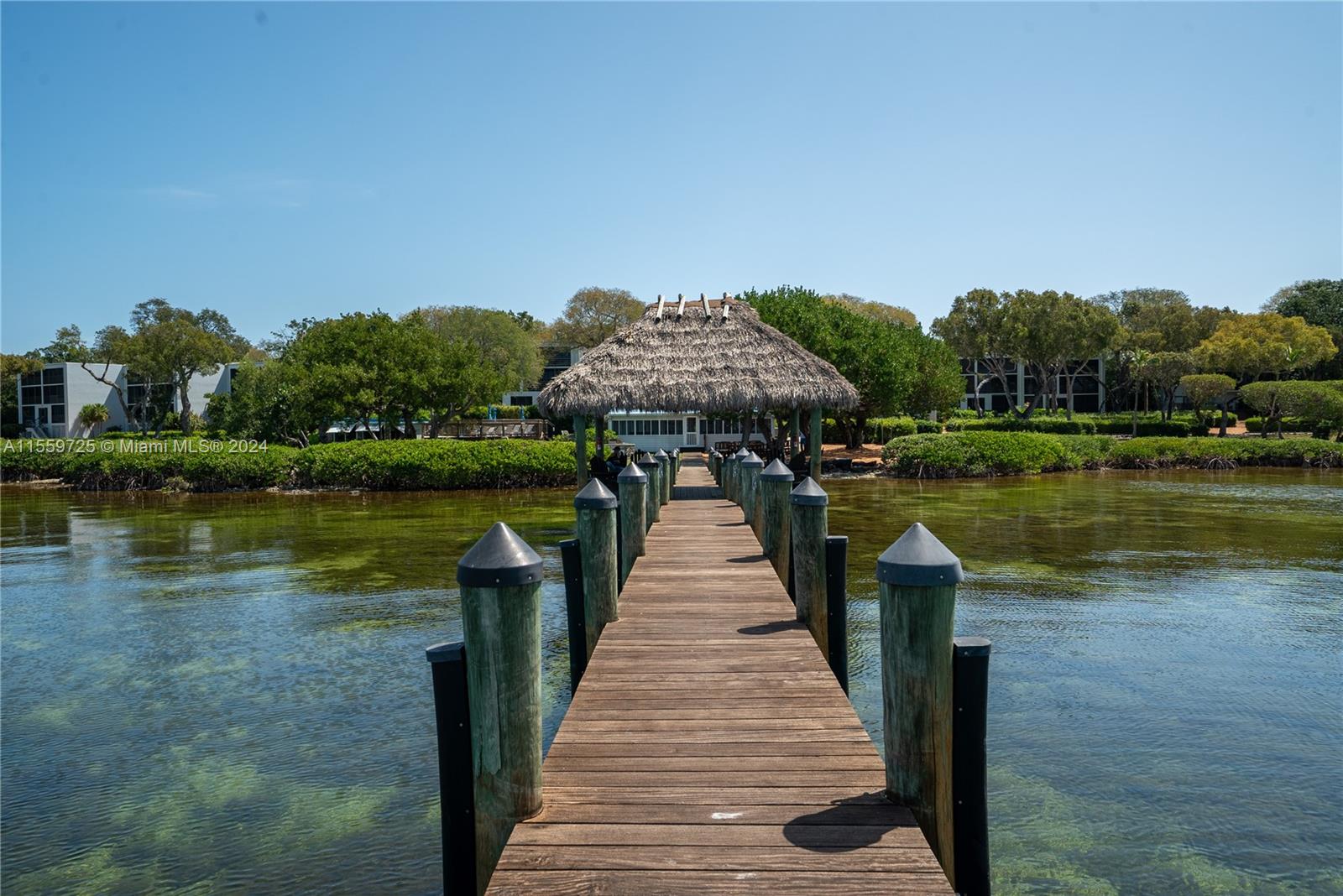 209 Sanctuary Dr., Unit 209 Key Largo, FL 33037 - Photo 2 of 43 a front view of a house with a yard