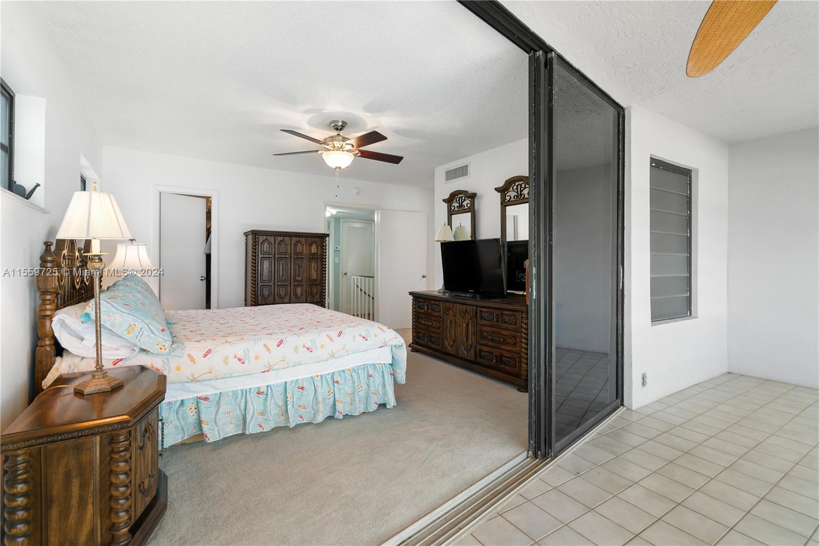 209 Sanctuary Dr., Unit 209 Key Largo, FL 33037 - Photo 22 of 43 a bedroom with a bed and a flat screen tv