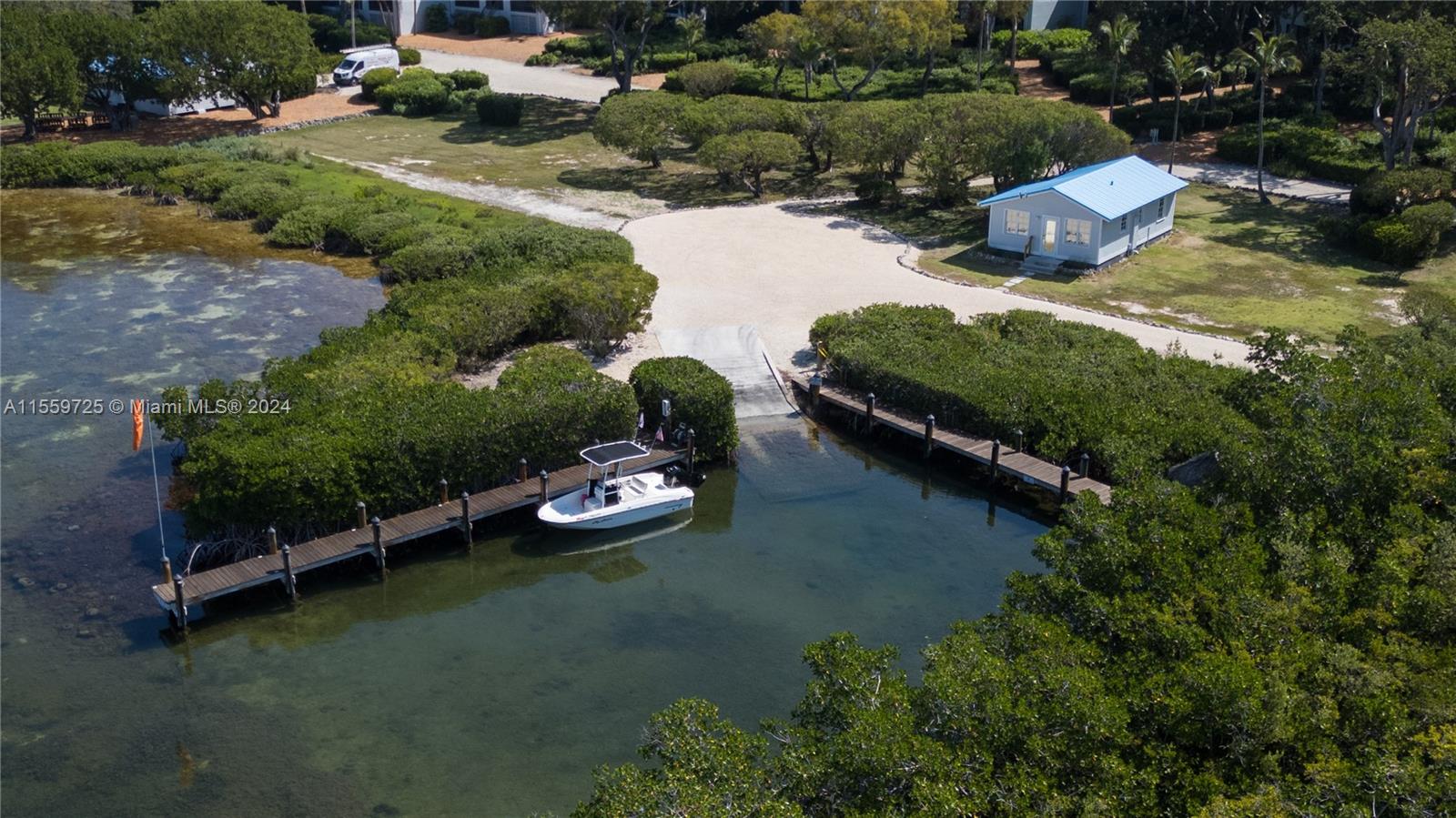 209 Sanctuary Dr., Unit 209 Key Largo, FL 33037 - Photo 30 of 43 an aerial view of a house with a yard and lake view