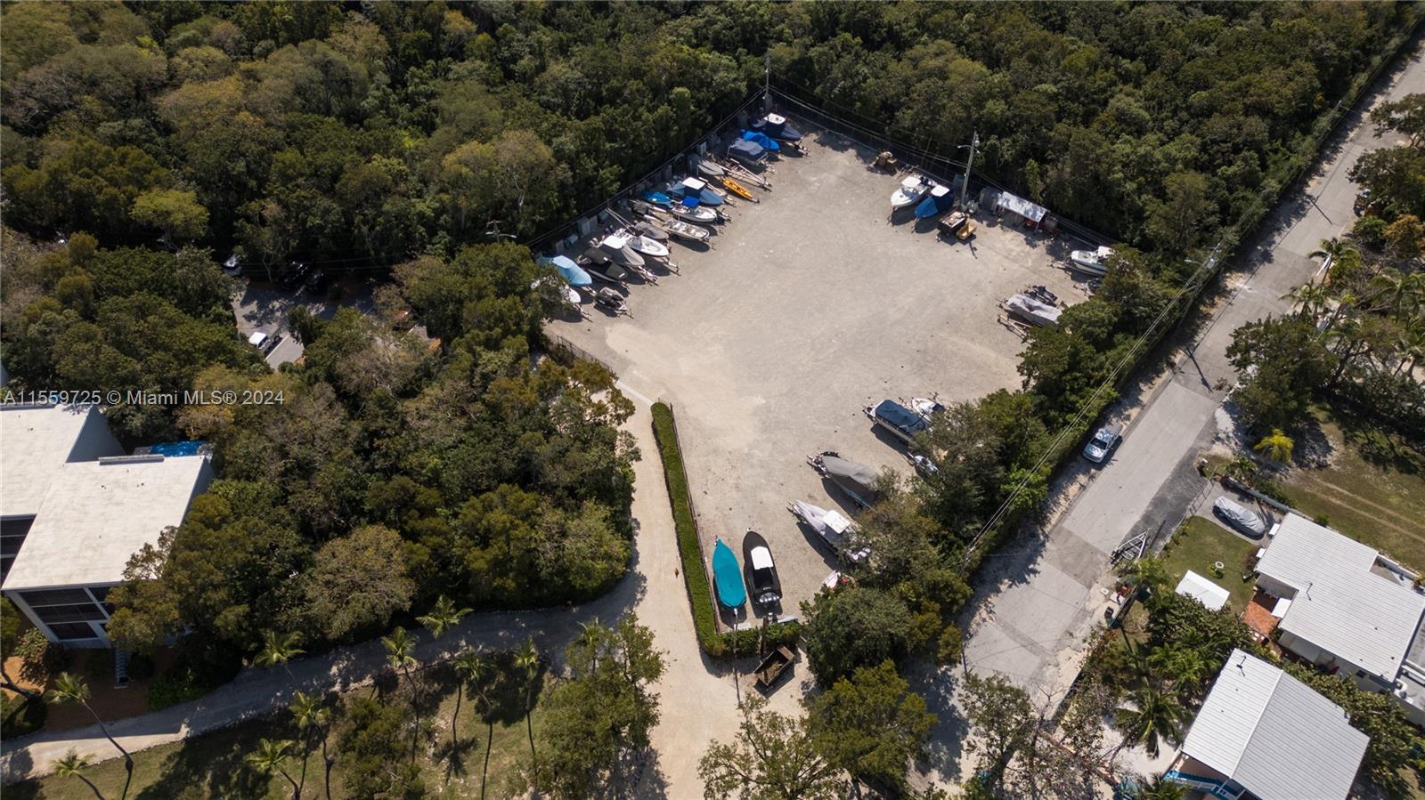 209 Sanctuary Dr., Unit 209 Key Largo, FL 33037 - Photo 31 of 43 an aerial view of a house with a yard and trees
