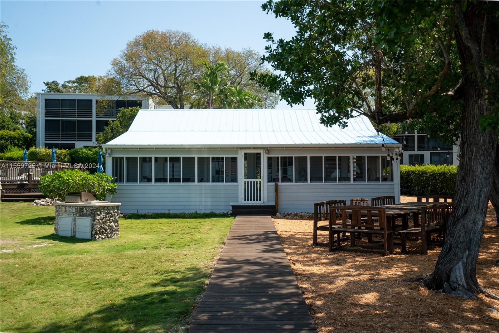 209 Sanctuary Dr., Unit 209 Key Largo, FL 33037 - Photo 34 of 43 a front view of a house with garden