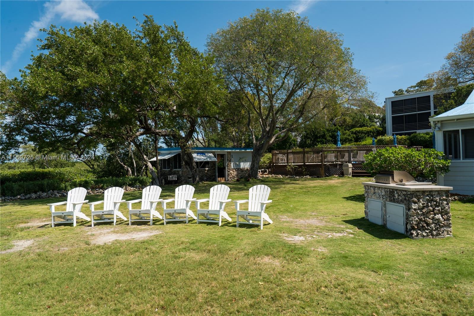 209 Sanctuary Dr., Unit 209 Key Largo, FL 33037 - Photo 37 of 43 a view of a chair and tables back yard of the house