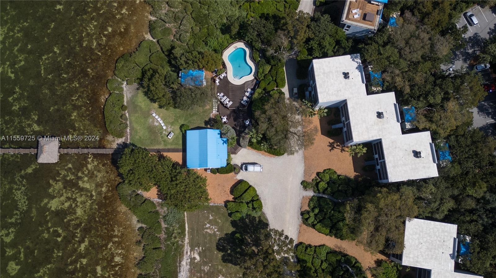 209 Sanctuary Dr., Unit 209 Key Largo, FL 33037 - Photo 38 of 43 an aerial view of a house with a yard and lake view