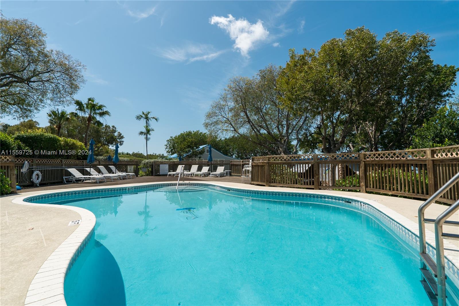 209 Sanctuary Dr., Unit 209 Key Largo, FL 33037 - Photo 41 of 43 a view of a swimming pool with a lounge chair