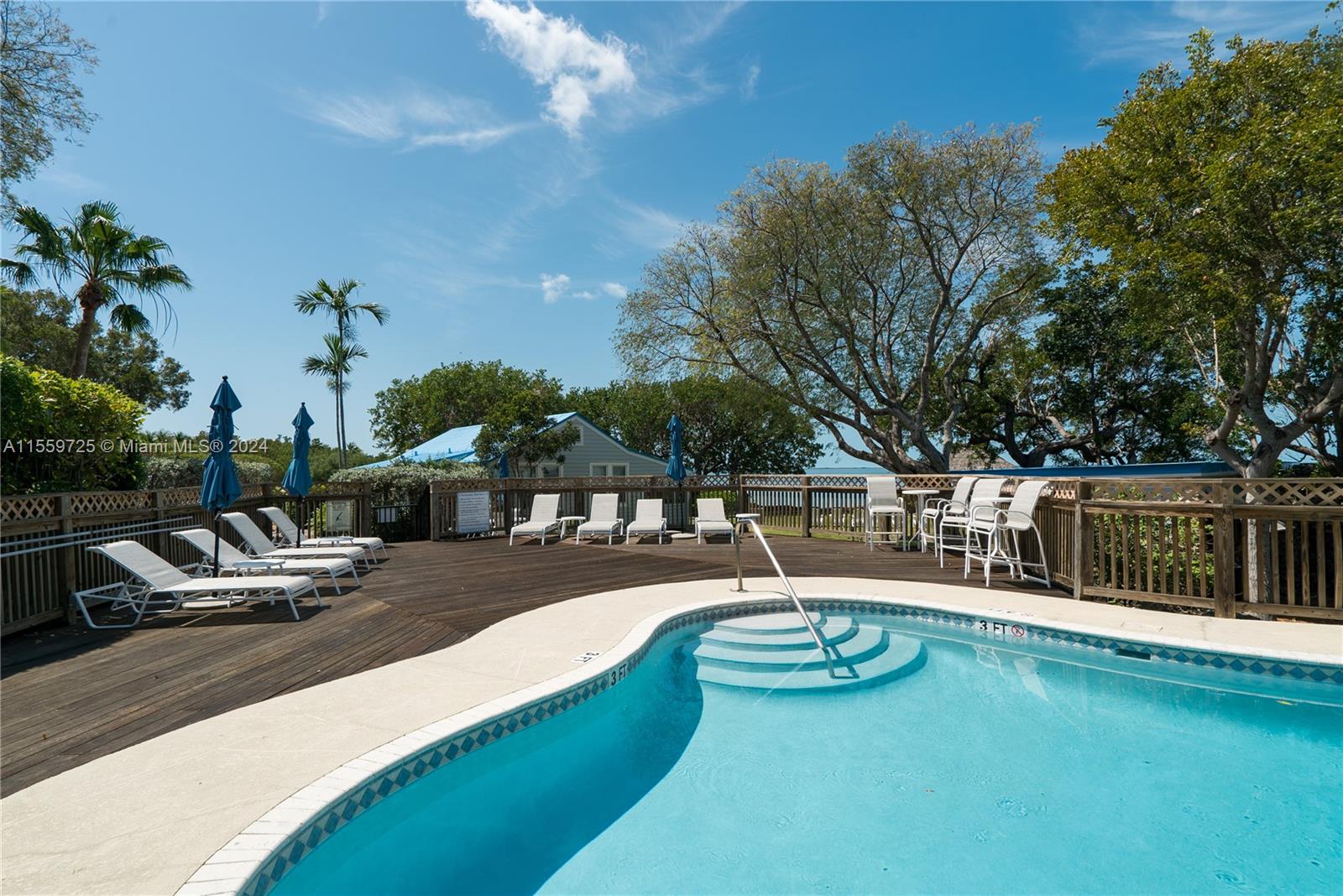 209 Sanctuary Dr., Unit 209 Key Largo, FL 33037 - Photo 42 of 43 a view of a swimming pool with lounge chairs