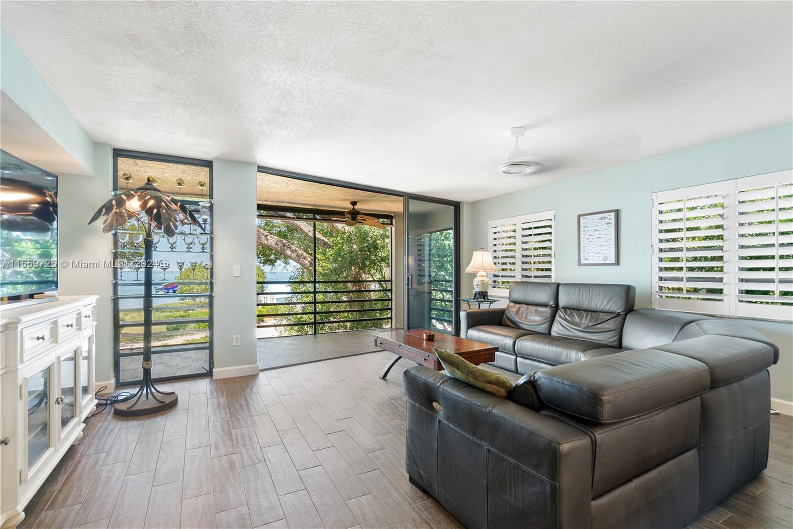 209 Sanctuary Dr., Unit 209 Key Largo, FL 33037 - Photo 7 of 43 a living room with furniture and large windows
