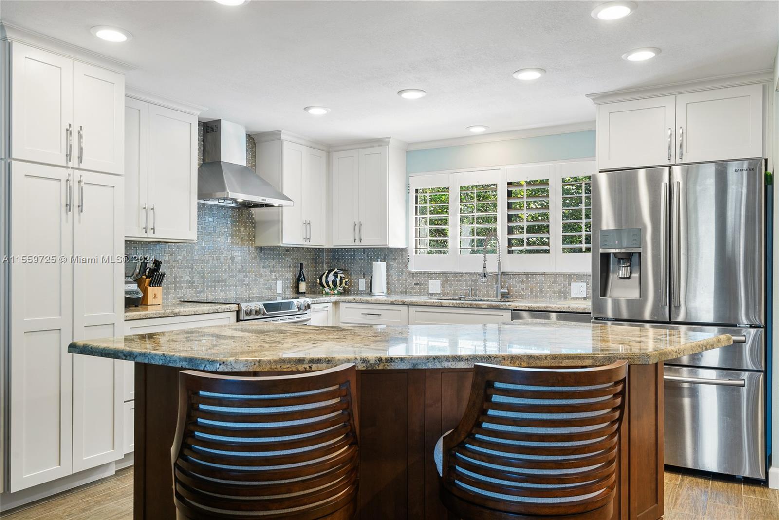 209 Sanctuary Dr., Unit 209 Key Largo, FL 33037 - Photo 10 of 43 a kitchen with kitchen island granite countertop appliances cabinets and a sink