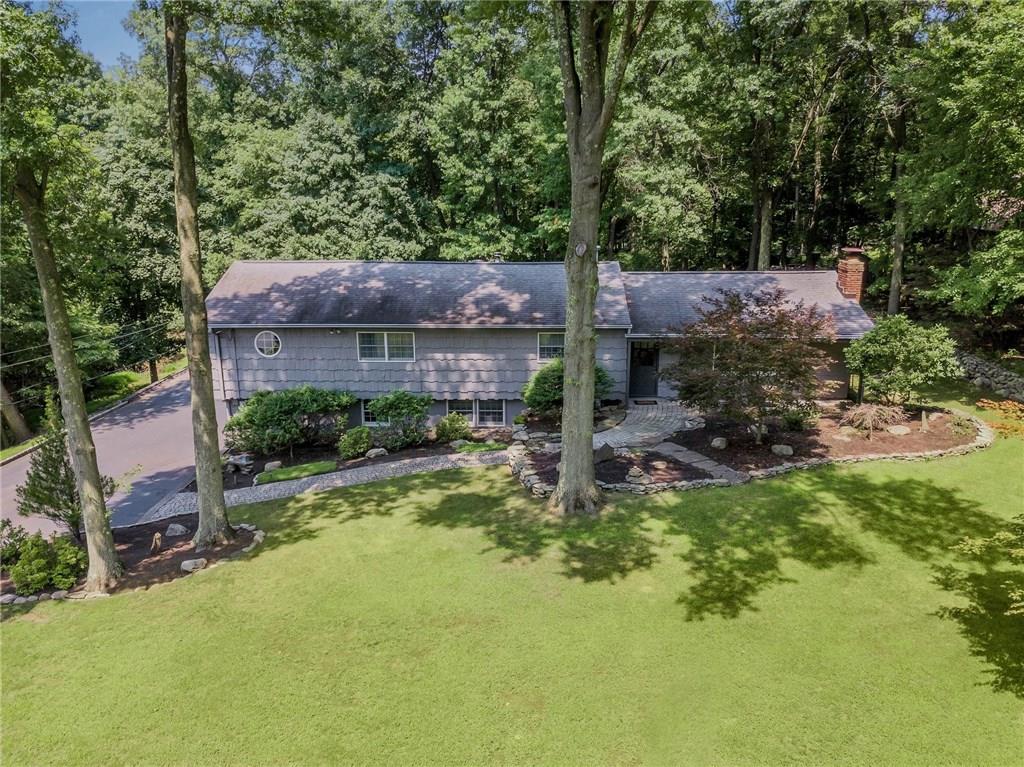 a aerial view of a house with swimming pool next to a big yard