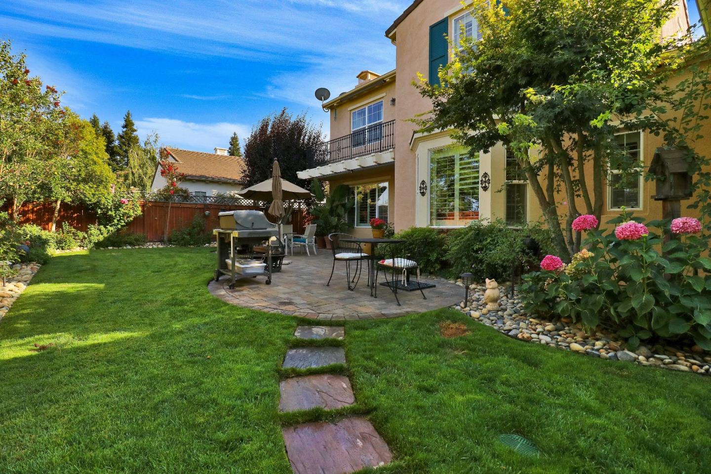 7120 Eagle Ridge Drive Gilroy, CA 95020 - Photo 18 of 21 a view of a chair and table in backyard of the house