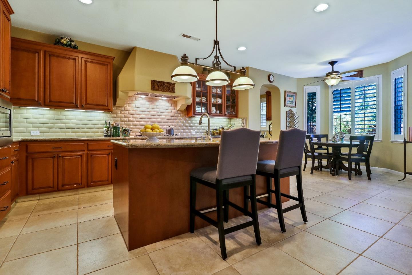 7120 Eagle Ridge Drive Gilroy, CA 95020 - Photo 8 of 21 a kitchen with stainless steel appliances granite countertop a sink a stove a dining table and chairs