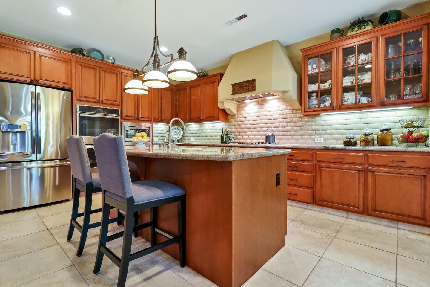 7120 Eagle Ridge Drive Gilroy, CA 95020 - Photo 9 of 21 a kitchen with stainless steel appliances granite countertop a sink and a refrigerator