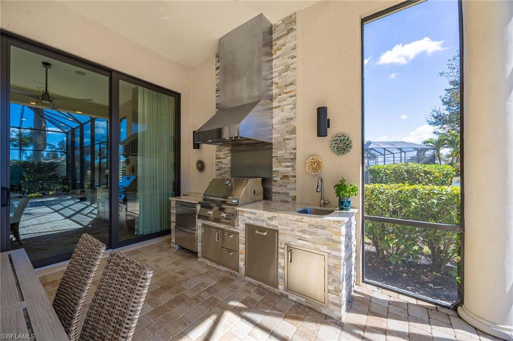 6502 Roma Way Naples, FL 34113 - Photo 11 of 43 a kitchen with a stove and a view of living room