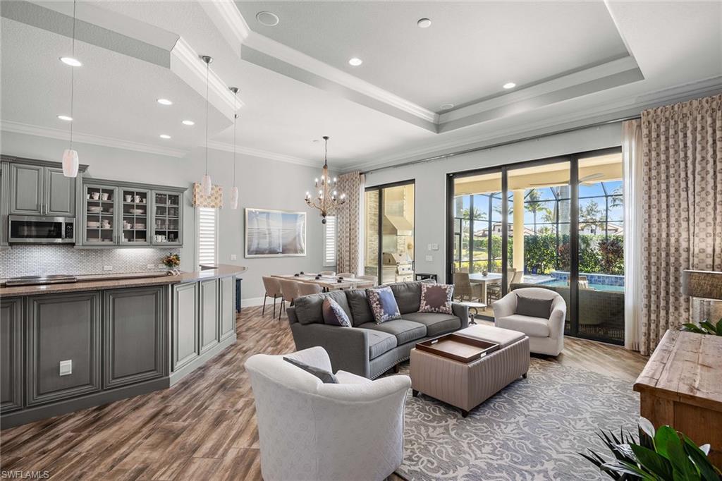 6502 Roma Way Naples, FL 34113 - Photo 20 of 43 a living room with furniture and a large window