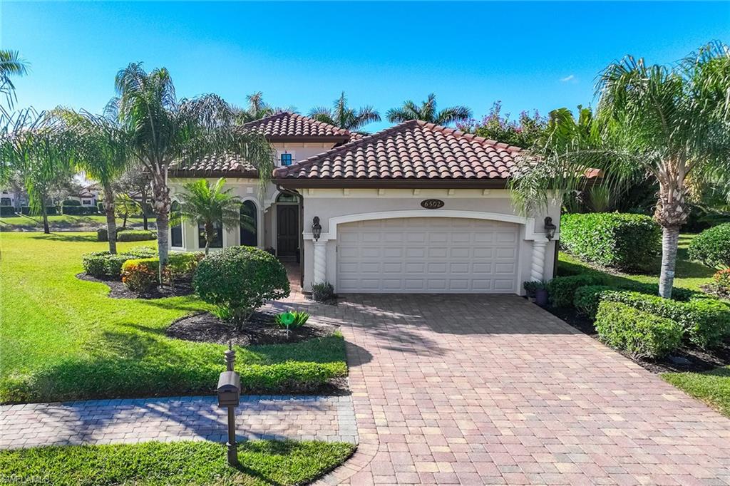 6502 Roma Way Naples, FL 34113 - Photo 2 of 43 a front view of house with garden