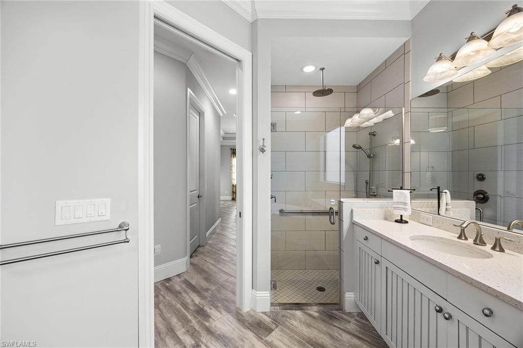 6502 Roma Way Naples, FL 34113 - Photo 26 of 43 a bathroom with a double vanity sink mirror and shower