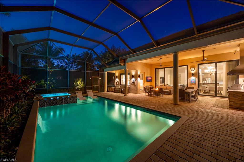 6502 Roma Way Naples, FL 34113 - Photo 35 of 43 a view of a swimming pool with a patio
