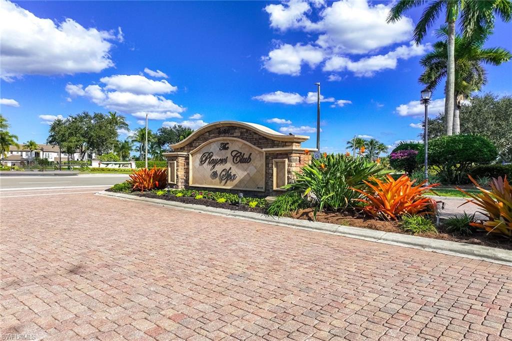 6502 Roma Way Naples, FL 34113 - Photo 38 of 43 a street view with flower plants and wooden fence