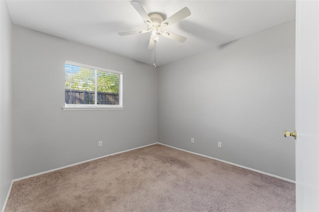 1805 Haymeadow Carrollton, TX 75007 - Photo 11 of 20 an empty room with windows and a chandelier fan