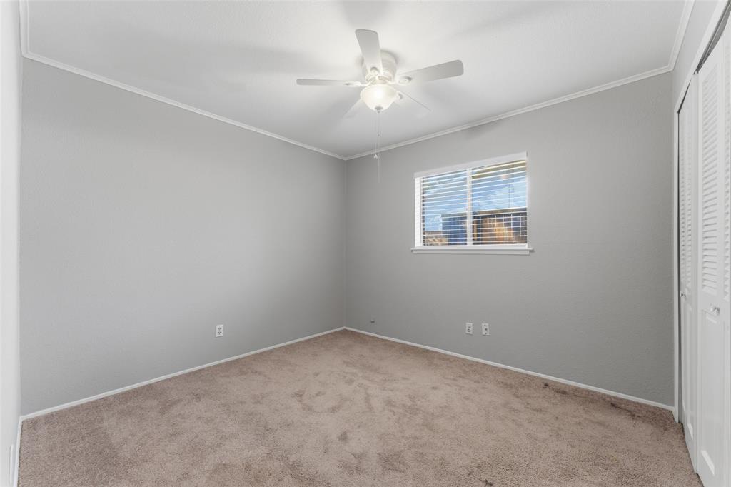 1805 Haymeadow Carrollton, TX 75007 - Photo 12 of 20 an empty room with a window and a ceiling fan