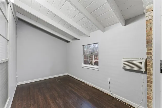 a view of a room with wooden floor and windows