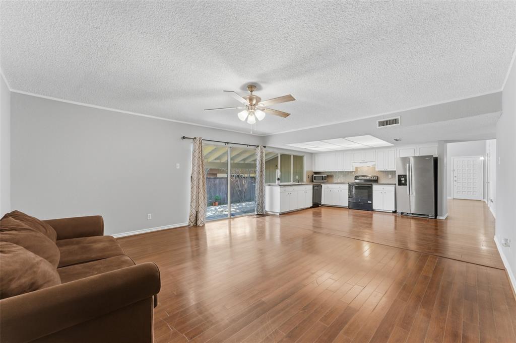 1805 Haymeadow Carrollton, TX 75007 - Photo 6 of 20 a view of an empty room with window and wooden floor