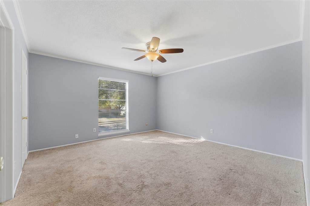 1805 Haymeadow Carrollton, TX 75007 - Photo 8 of 20 an empty room with windows and a ceiling fan