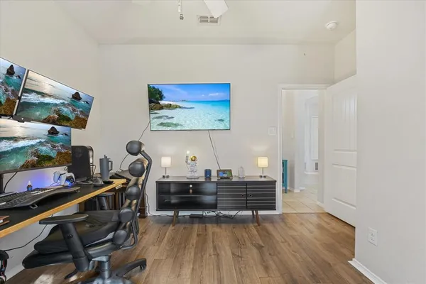 a view of a workspace with furniture and a window