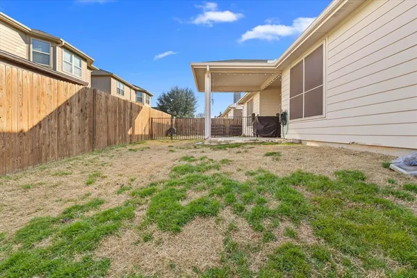 a view of a house with backyard and sitting area