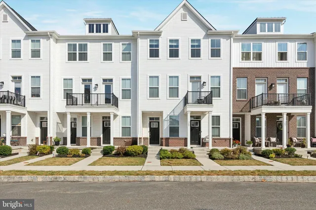 a view of of a building with a yard next to a road