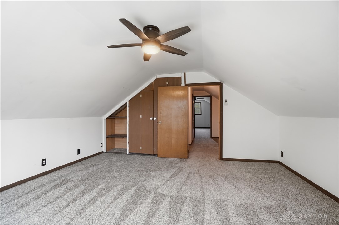 7553 Coffin Station Road Springfield, OH 45502 - Photo 65 of 95 This spacious room features vaulted ceilings and plush carpeting, offering a cozy and inviting atmosphere.