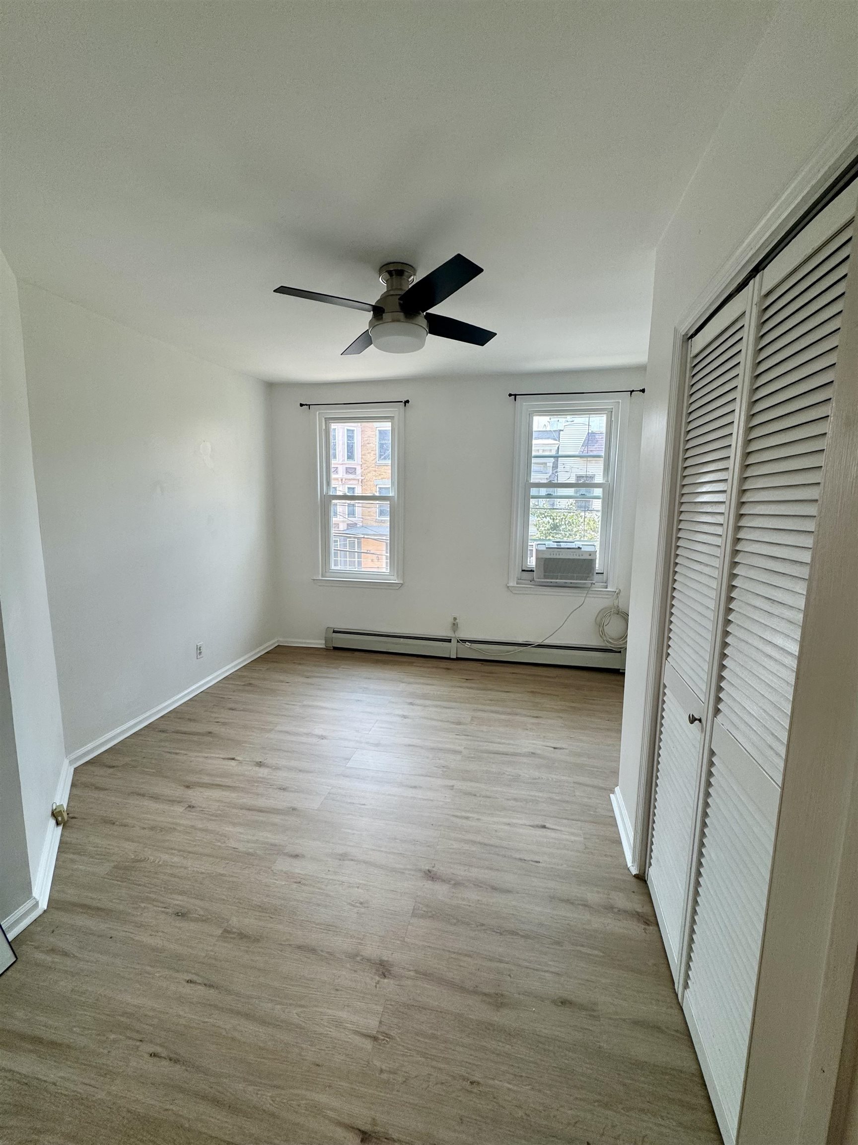 421 Adams Street, Unit 2L Hoboken, NJ 07030 - Photo 7 of 19 wooden floor in an empty room with a window