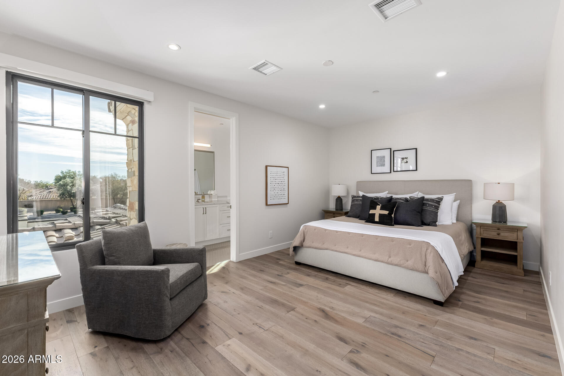 6500 East Camelback Road, Unit 1010 Scottsdale, AZ 85251 - Photo 17 of 24 a spacious bedroom with a bed and a couch