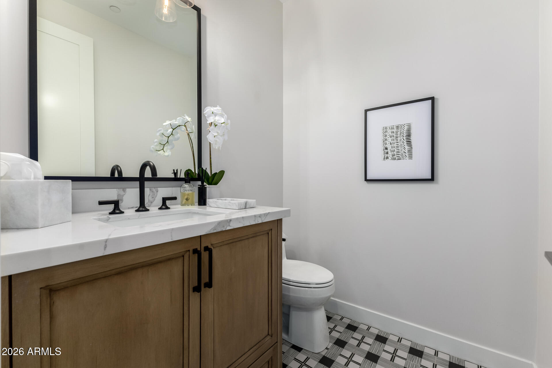 6500 East Camelback Road, Unit 1010 Scottsdale, AZ 85251 - Photo 10 of 24 a bathroom with a toilet sink and mirror