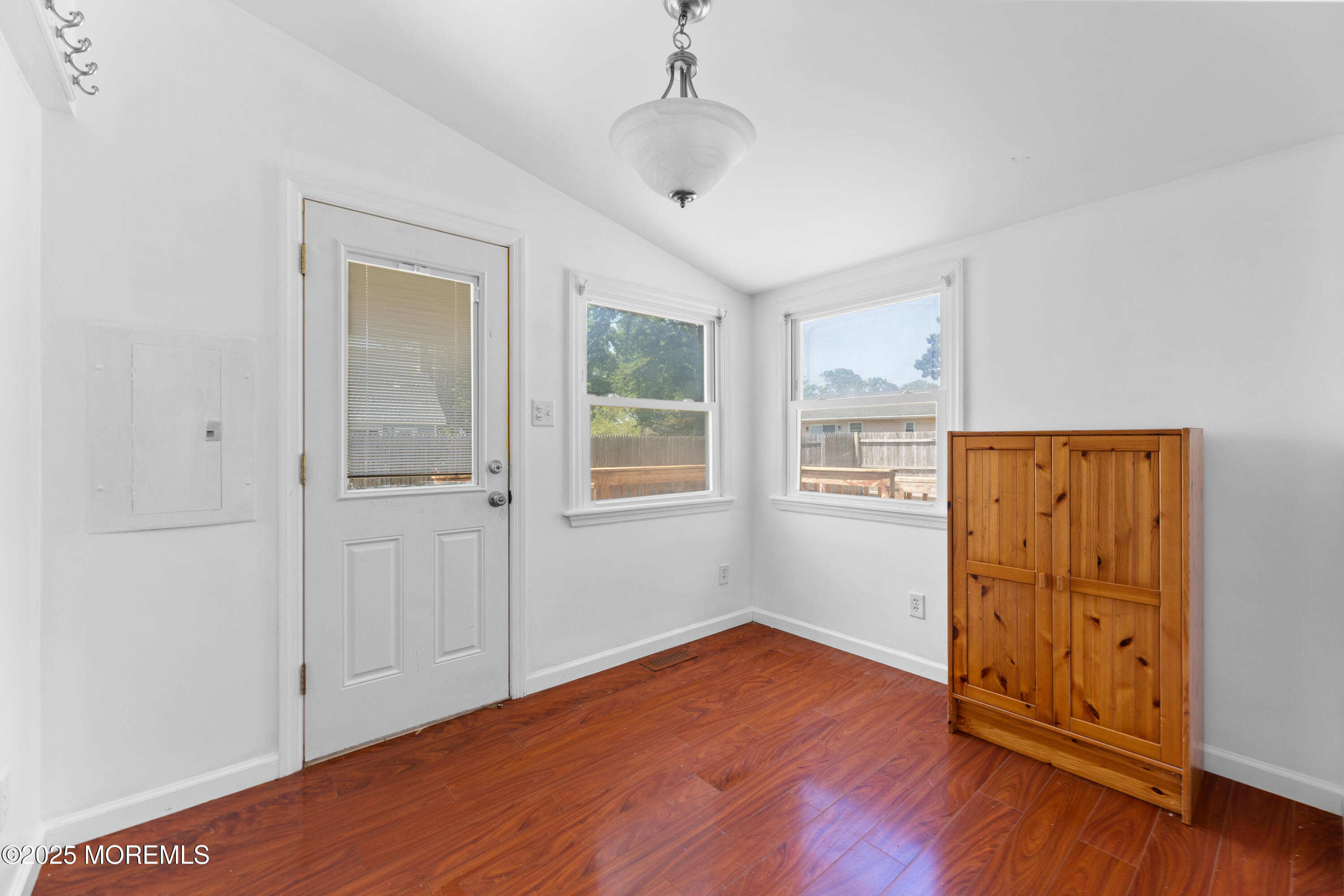 474 Burnt Bark Road Brick, NJ 08723 - Photo 14 of 28 an empty room with wooden floor cabinet and windows