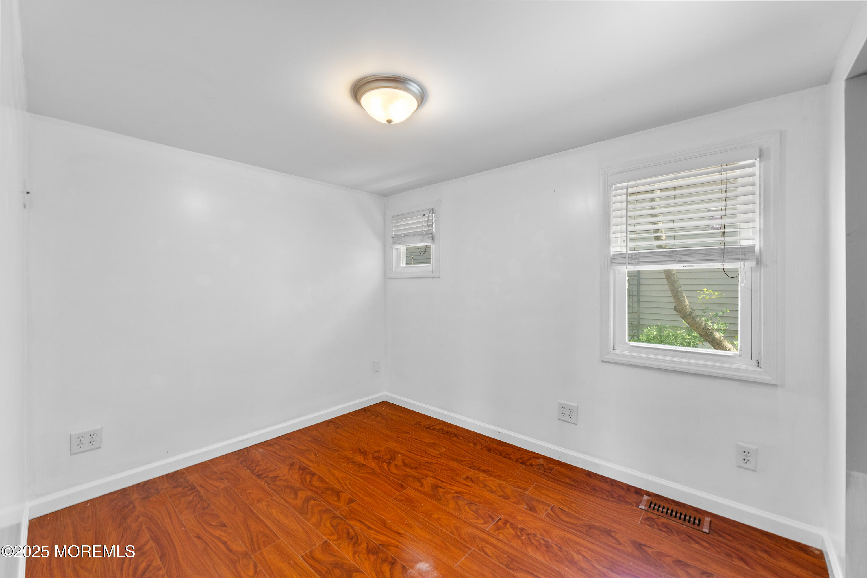 474 Burnt Bark Road Brick, NJ 08723 - Photo 16 of 28 an empty room with wooden floor and windows
