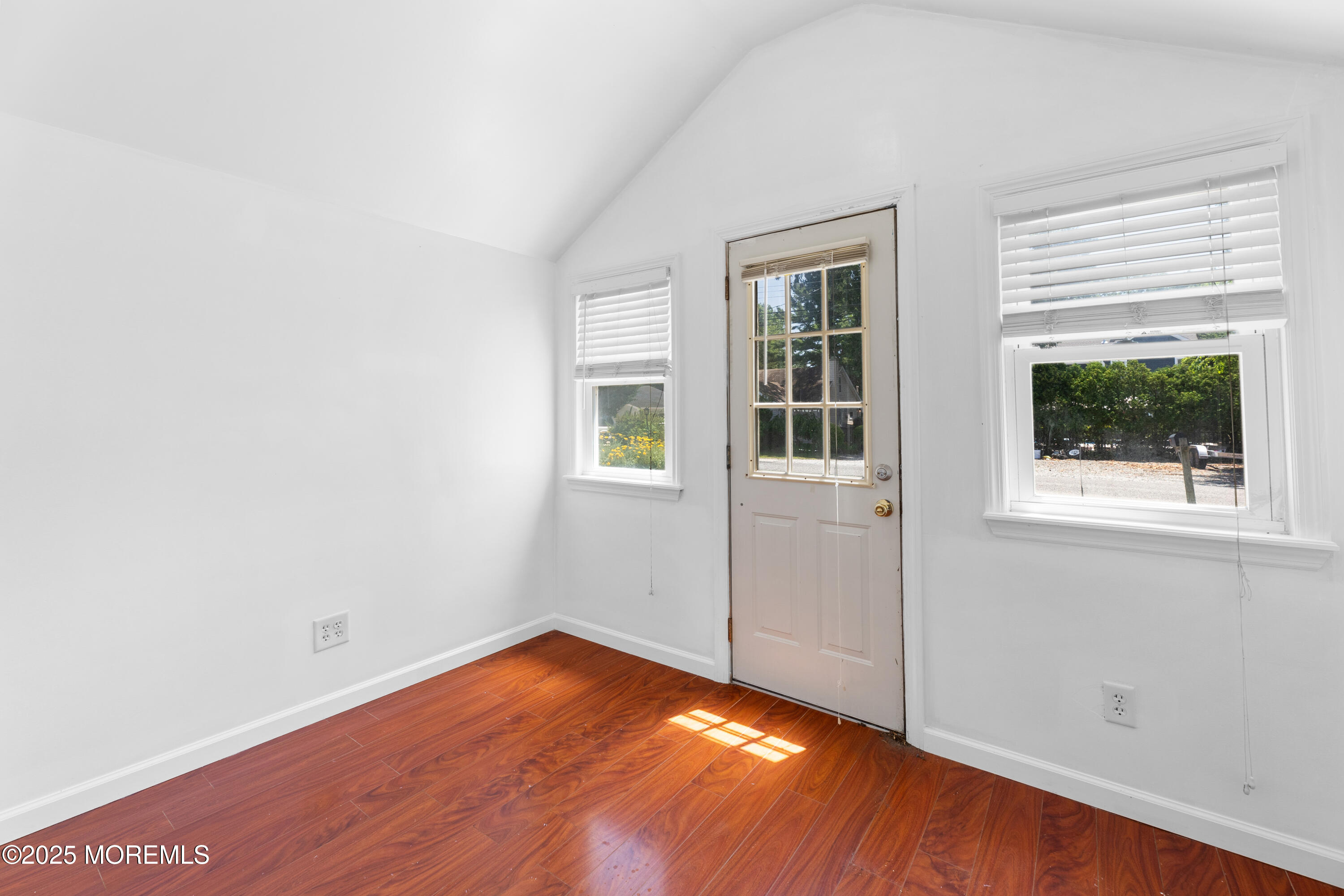 474 Burnt Bark Road Brick, NJ 08723 - Photo 6 of 28 an empty room with wooden floor and windows
