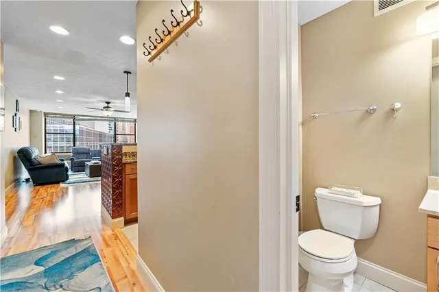a bathroom with a toilet sink and mirror