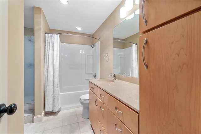 a bathroom with a sink a mirror and a shower