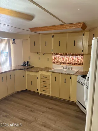 a kitchen with a refrigerator and a sink