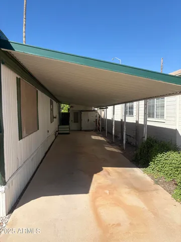 a balcony with furniture and a potted plant