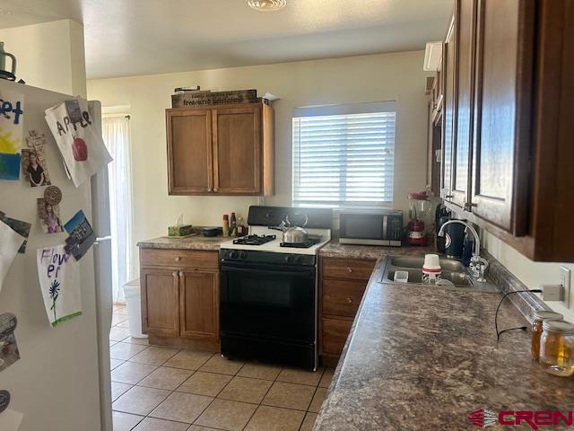 726 East 3rd Street Cortez, CO 81321 - Photo 2 of 20 a large kitchen with granite countertop a sink stove and refrigerator