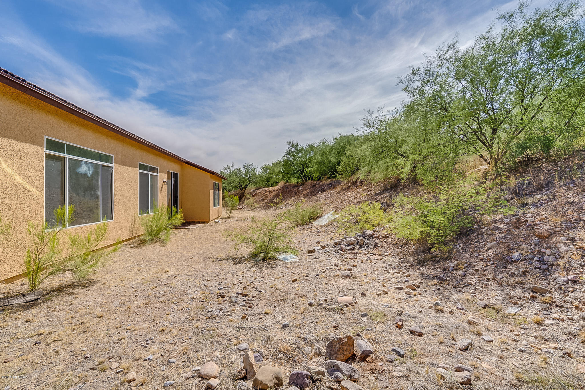 410 Wrightson Street Rio Rico, AZ 85648 - Photo 45 of 50 a front view of a house with a yard