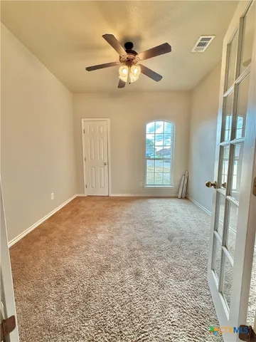 a view of an empty room with a window
