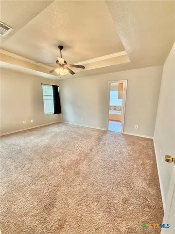 an empty room with closet and a ceiling fan