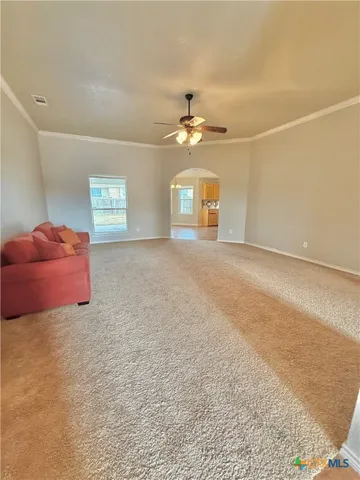 a big room with closet and a chandelier fan