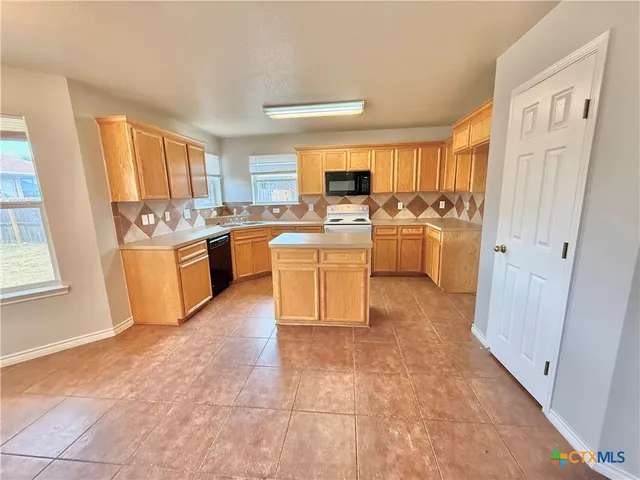 a kitchen with a sink and white cabinets